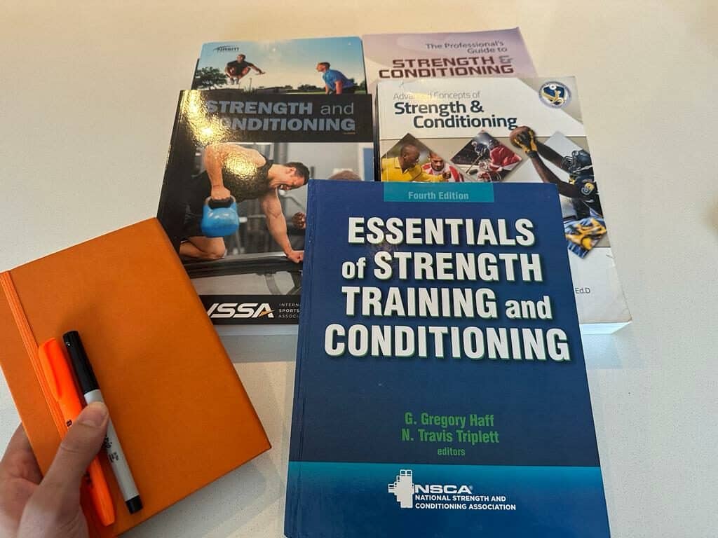 Best strength and conditioning certifications with a notebook, sharpie, and a highlighter.