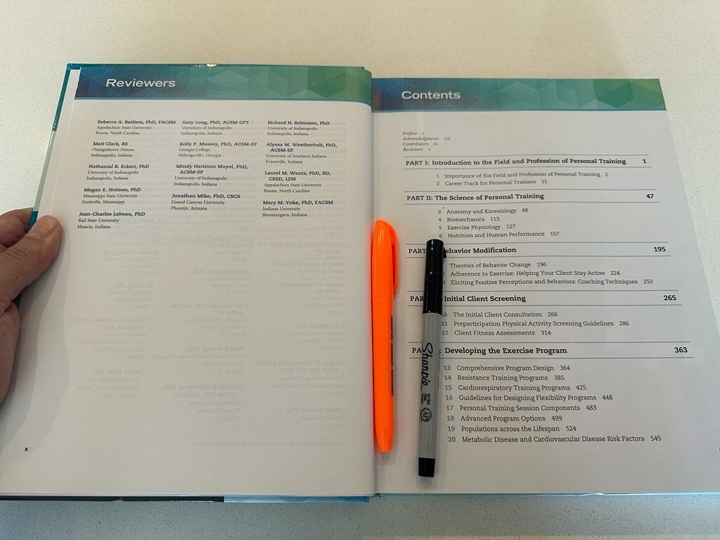 ACSM CPT textbook open and showing the table of contents and reviewers pages